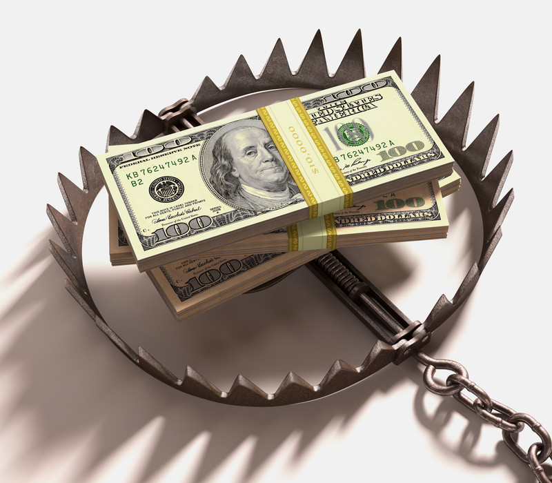 Stacks of hundred dollar bills set in a bear trap.